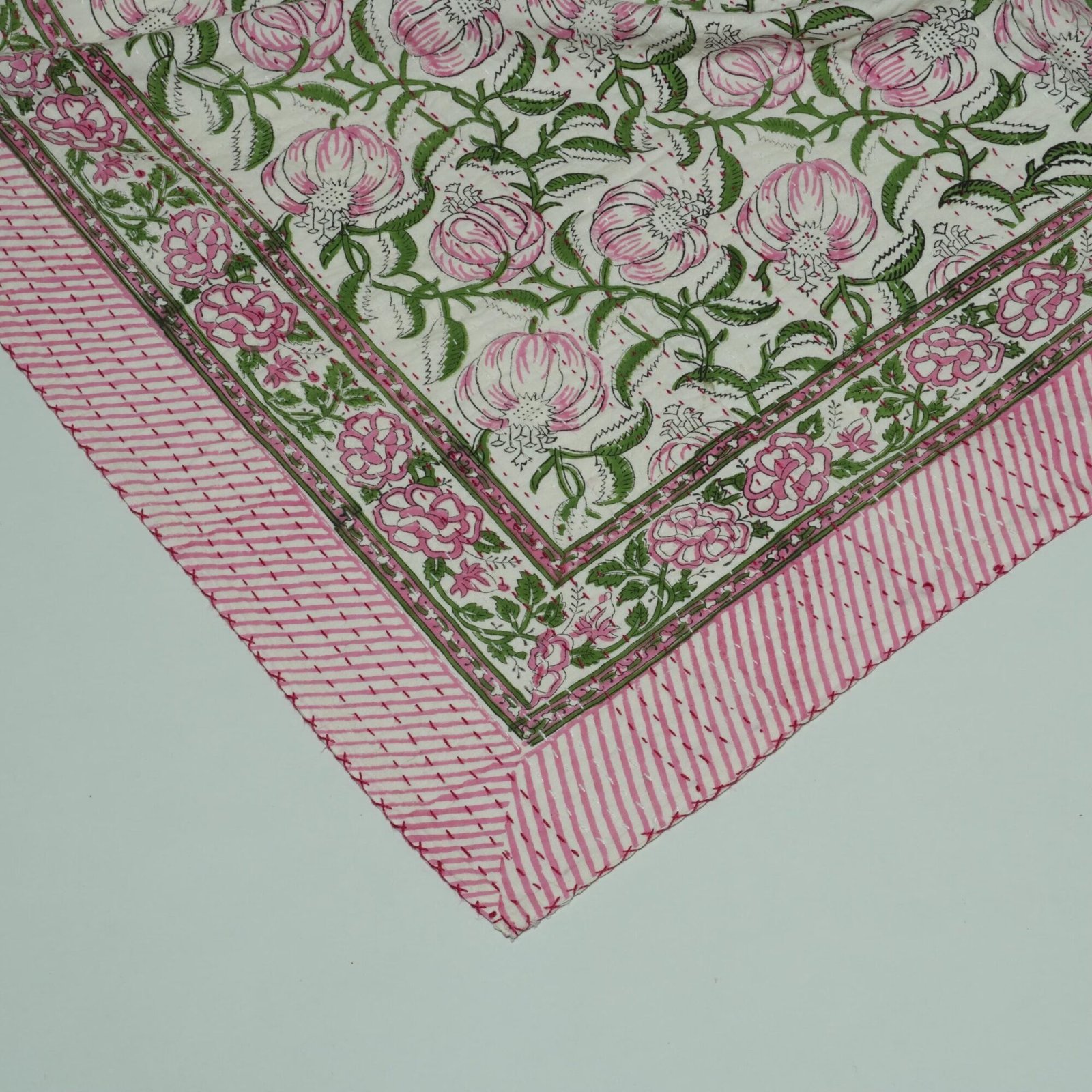 Handmade pink floral block print Kantha quilt on white cotton fabric