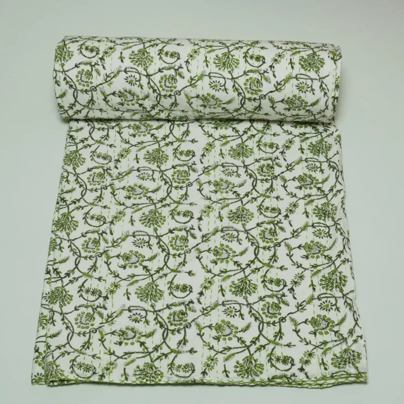 “Handmade green floral block print Kantha quilt on white cotton fabric with hand stitching”
