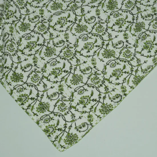 “Handmade green floral block print Kantha quilt on white cotton fabric with hand stitching”