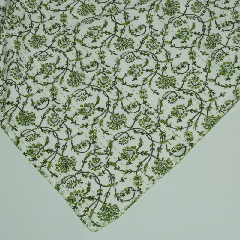 “Handmade green floral block print Kantha quilt on white cotton fabric with hand stitching”