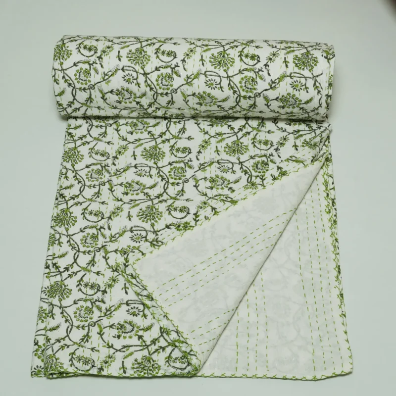 “Handmade green floral block print Kantha quilt on white cotton fabric with hand stitching”