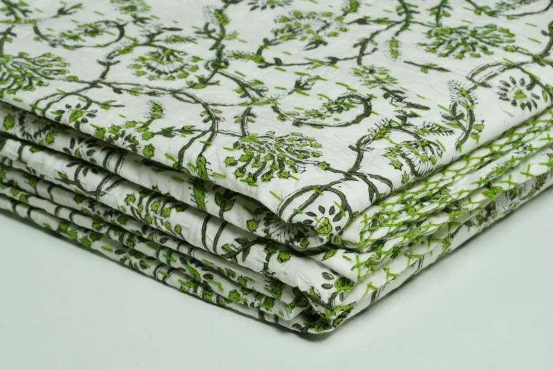 “Handmade green floral block print Kantha quilt on white cotton fabric with hand stitching”