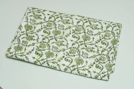 “Handmade green floral block print Kantha quilt on white cotton fabric with hand stitching”