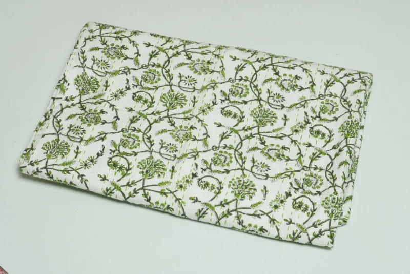 “Handmade green floral block print Kantha quilt on white cotton fabric with hand stitching”