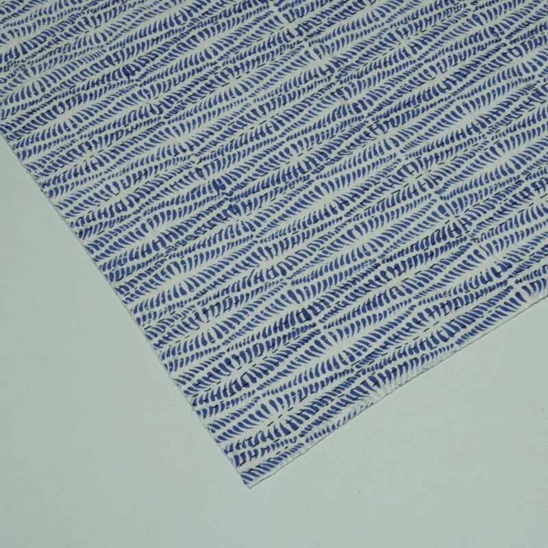 Rolled blue block print Kantha cotton fabric with geometric leaf pattern on white base by omradecor