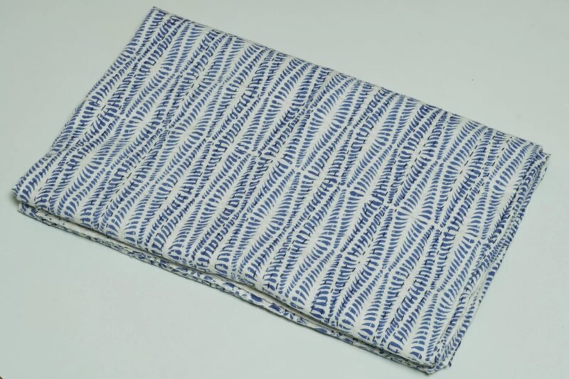 Rolled blue block print Kantha cotton fabric with geometric leaf pattern on white base by omradecor