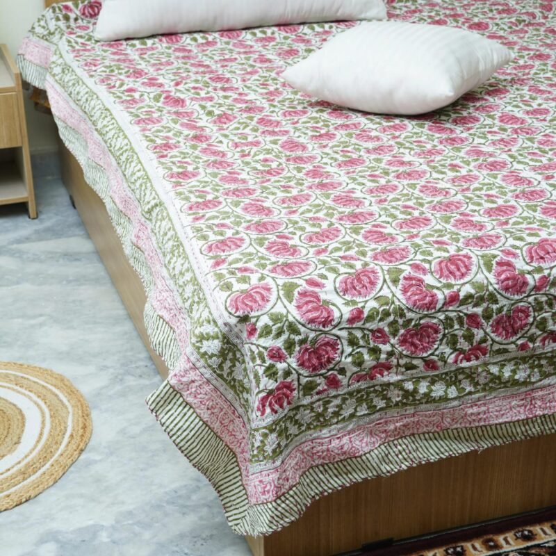 Handmade pink floral block print Kantha quilt in pure cotton with green vine design and traditional Indian stitching