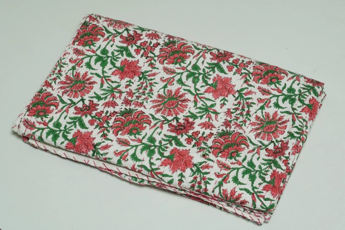 White floral block print Kantha quilt made from pure cotton, featuring red floral patterns with green leaves, handmade and reversible bedspread