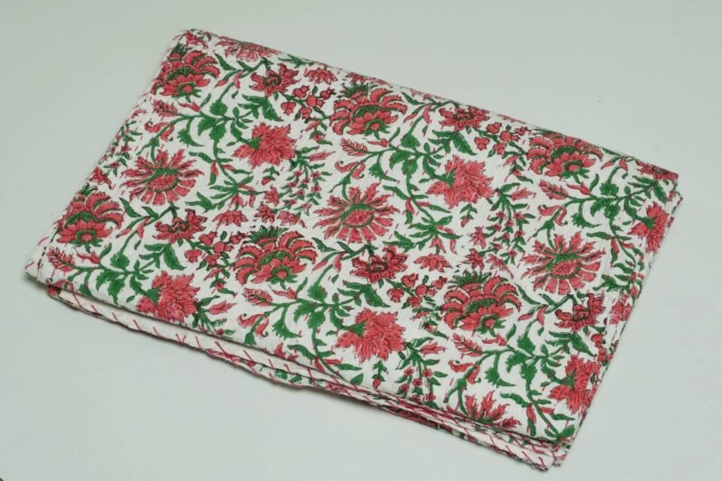 White floral block print Kantha quilt made from pure cotton, featuring red floral patterns with green leaves, handmade and reversible bedspread