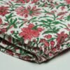 White floral block print Kantha quilt made from pure cotton, featuring red floral patterns with green leaves, handmade and reversible bedspread