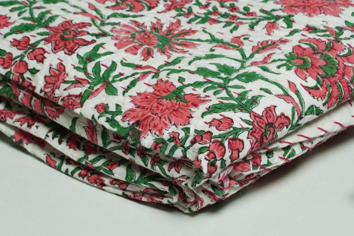 White floral block print Kantha quilt made from pure cotton, featuring red floral patterns with green leaves, handmade and reversible bedspread