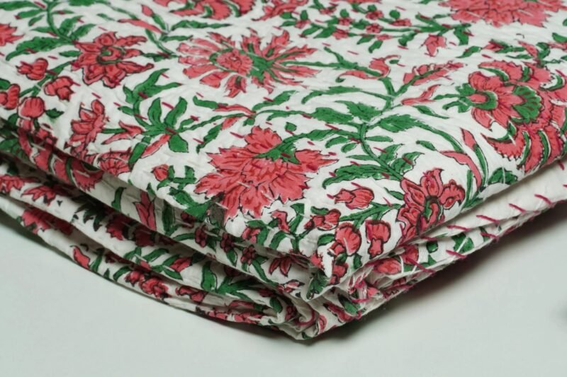 White floral block print Kantha quilt made from pure cotton, featuring red floral patterns with green leaves, handmade and reversible bedspread
